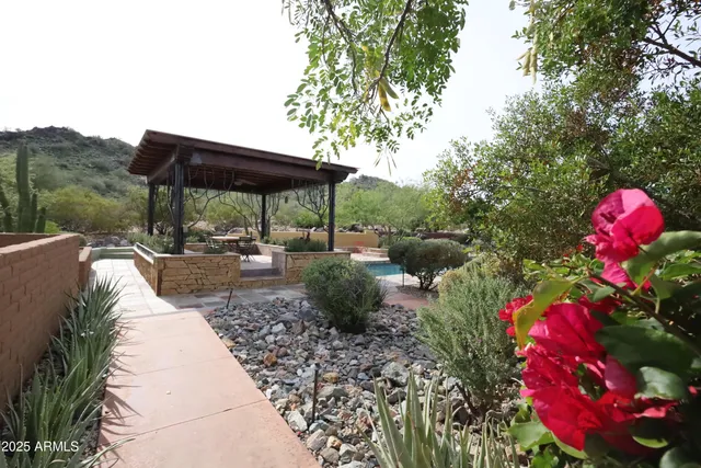 a view of a room with wooden floor and a ceiling fan