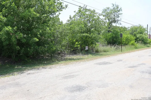a view of a road with a trees in the background
