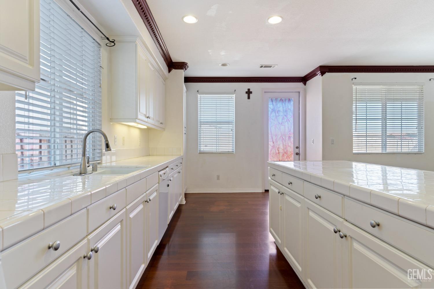 Undisclosed Address Bakersfield, CA 93306 - Photo 13 of 30 a large kitchen with granite countertop white cabinets and a window