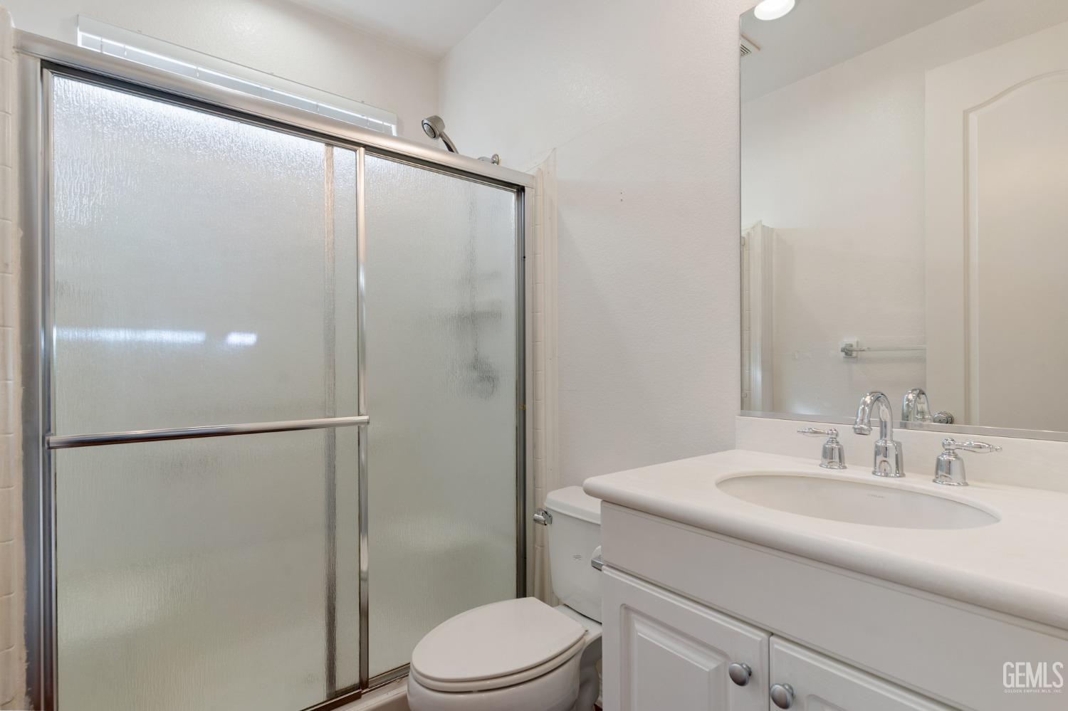 Undisclosed Address Bakersfield, CA 93306 - Photo 16 of 30 a bathroom with a granite countertop sink toilet and shower