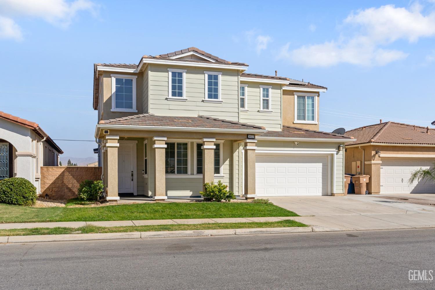 Undisclosed Address Bakersfield, CA 93306 - Photo 2 of 30 a front view of a house with a yard