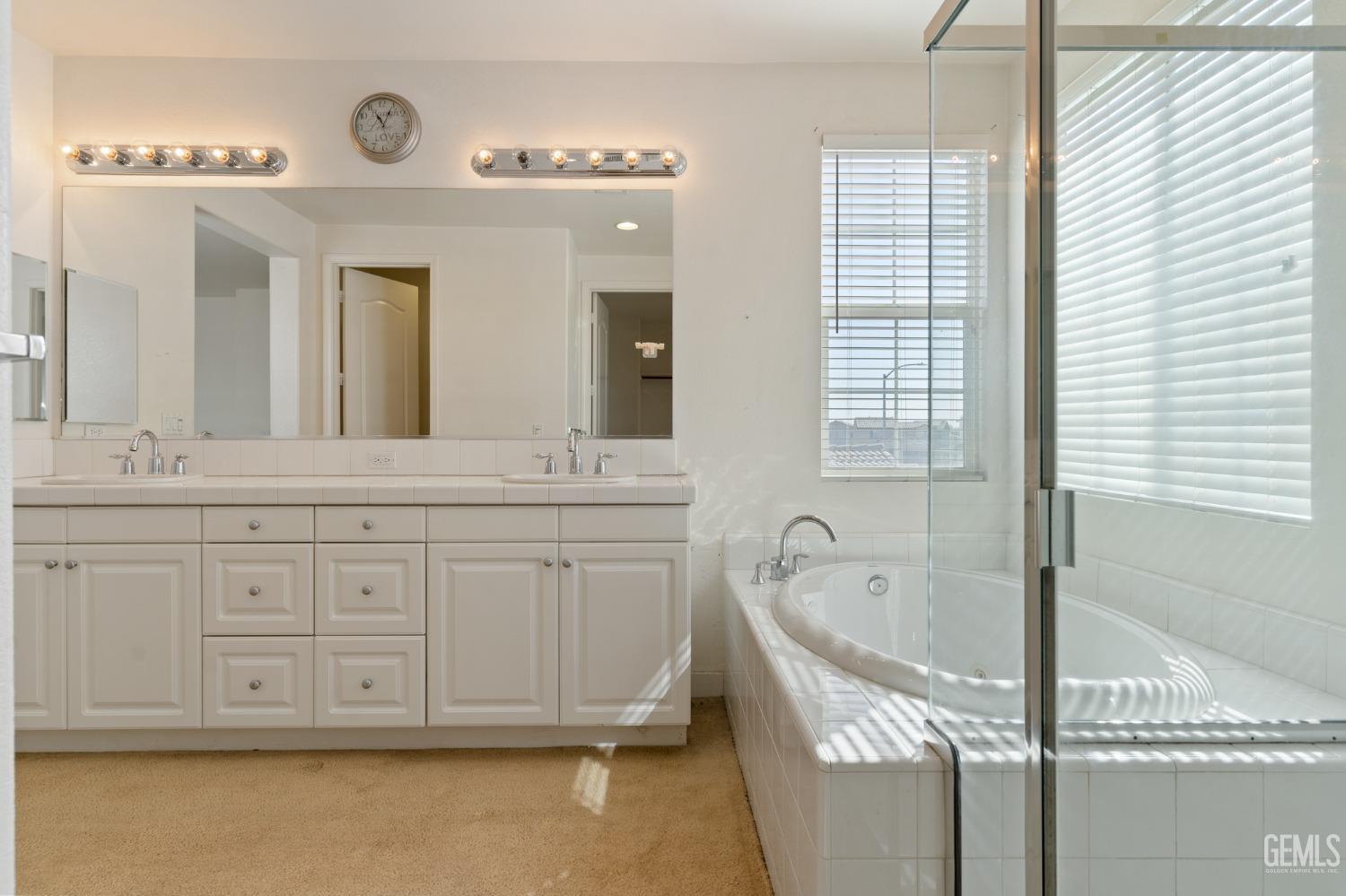 Undisclosed Address Bakersfield, CA 93306 - Photo 27 of 30 a bathroom with a tub sink and mirror