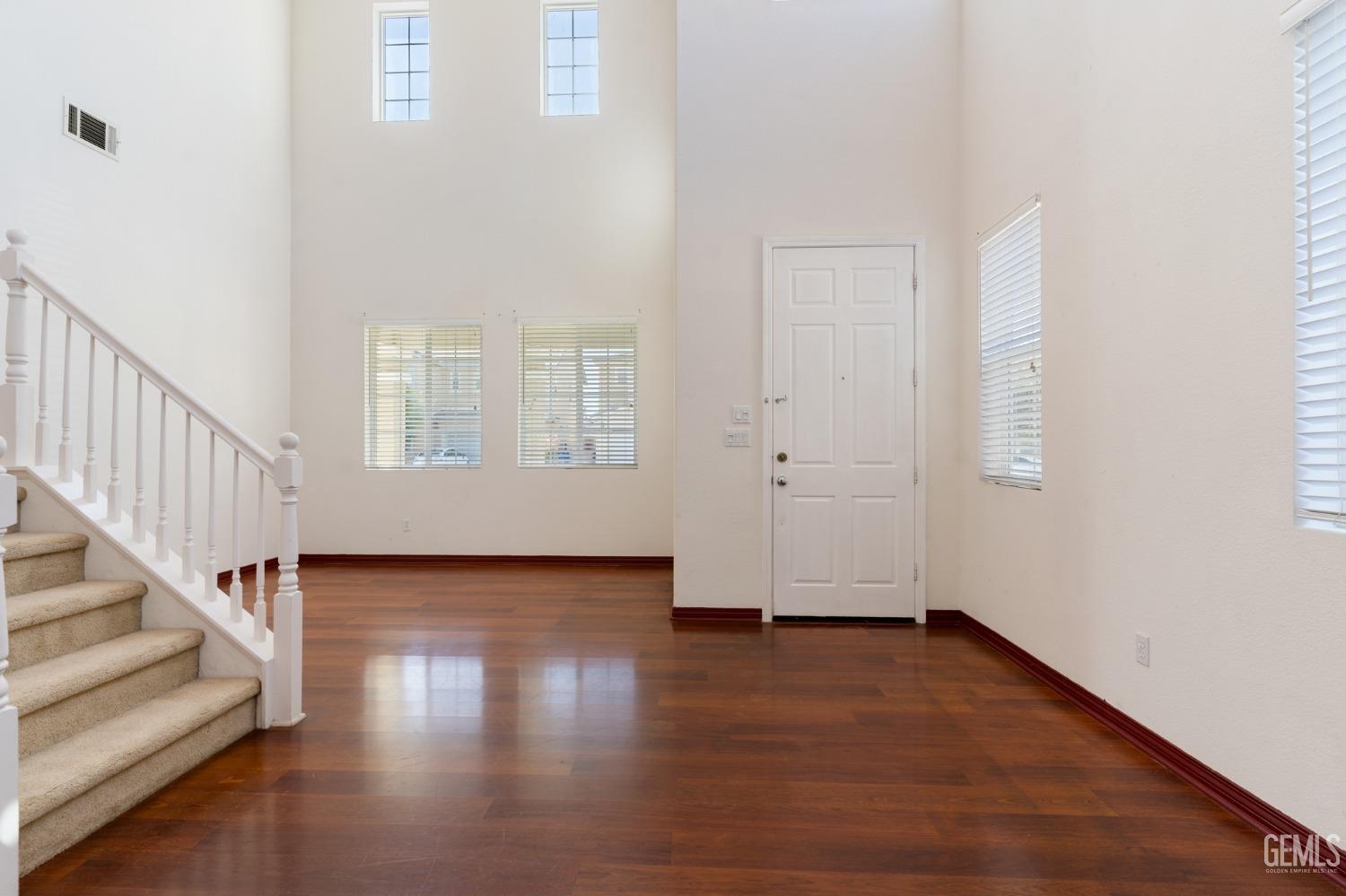 Undisclosed Address Bakersfield, CA 93306 - Photo 3 of 30 a view of an empty room with wooden floor and a window