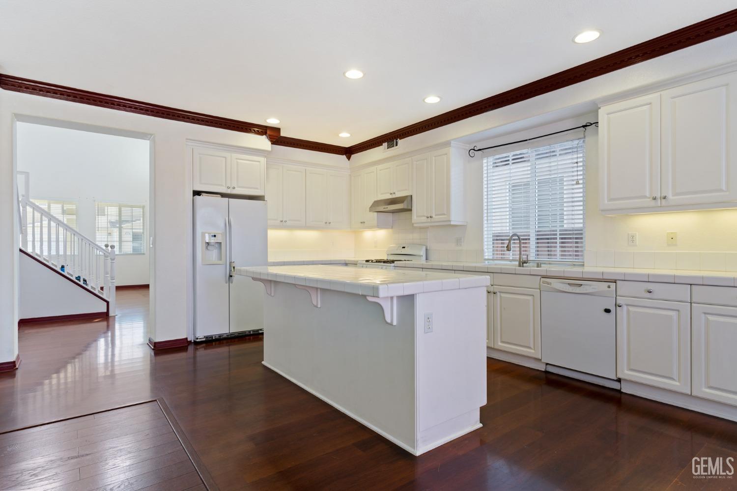 Undisclosed Address Bakersfield, CA 93306 - Photo 8 of 30 a kitchen with granite countertop white cabinets and white appliances