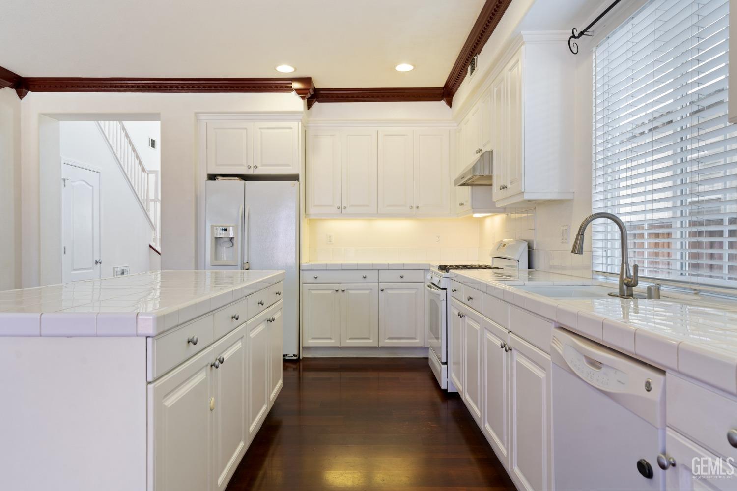 Undisclosed Address Bakersfield, CA 93306 - Photo 9 of 30 a kitchen with white cabinets and sink