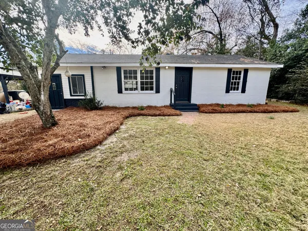 a backyard of a house with yard and outdoor seating