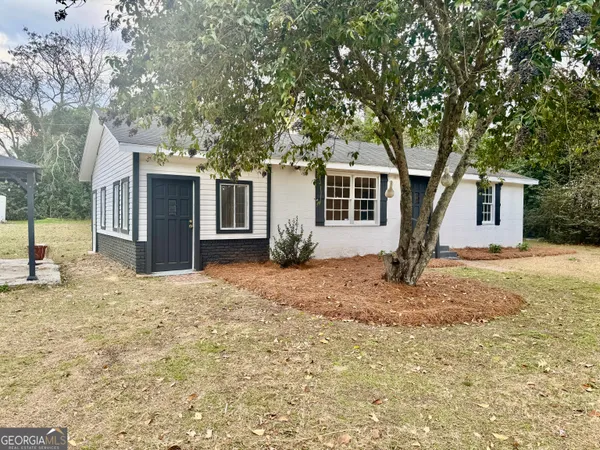 a front view of a house with yard porch and seating area
