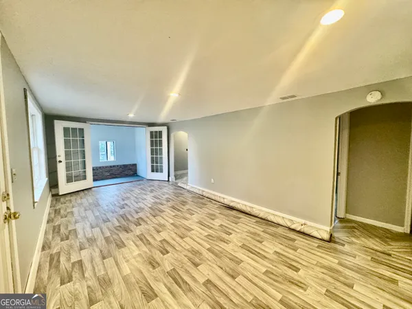 a spacious bedroom with a bed and a window