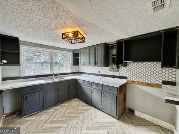 a kitchen with stainless steel appliances granite countertop a sink and a stove top oven