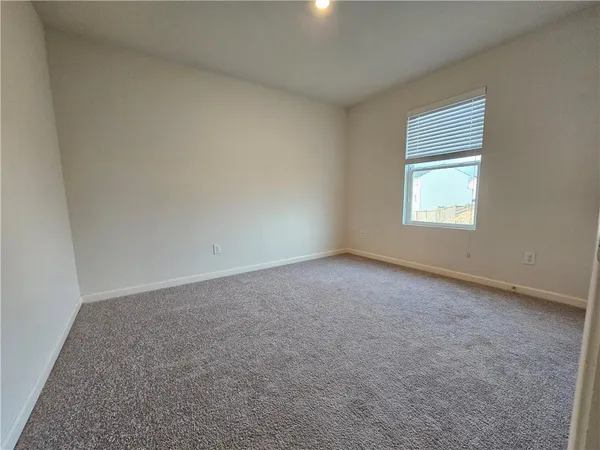 a view of an empty room and closet area