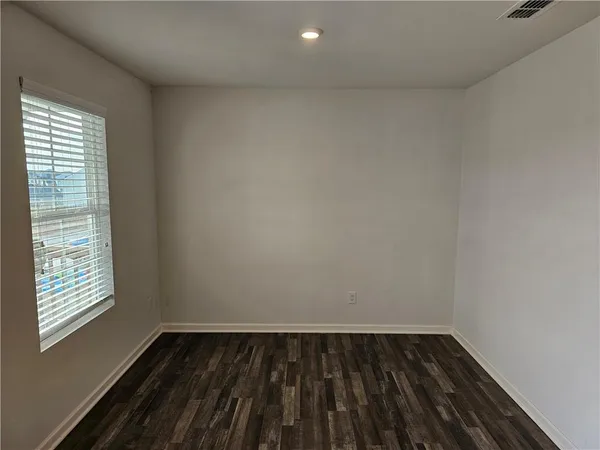 a view of an empty room and wooden floor