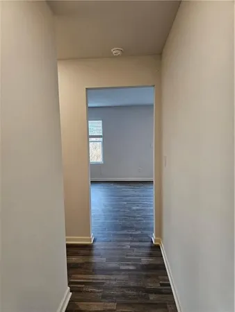 a view of a hallway with wooden floor