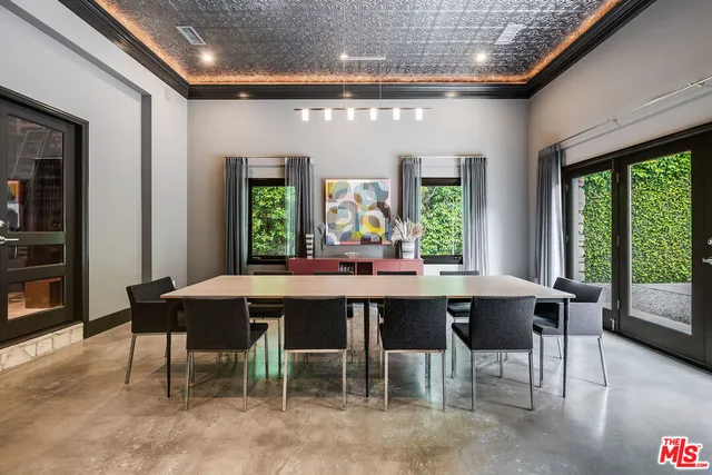 a dining room with furniture a chandelier and wooden floor