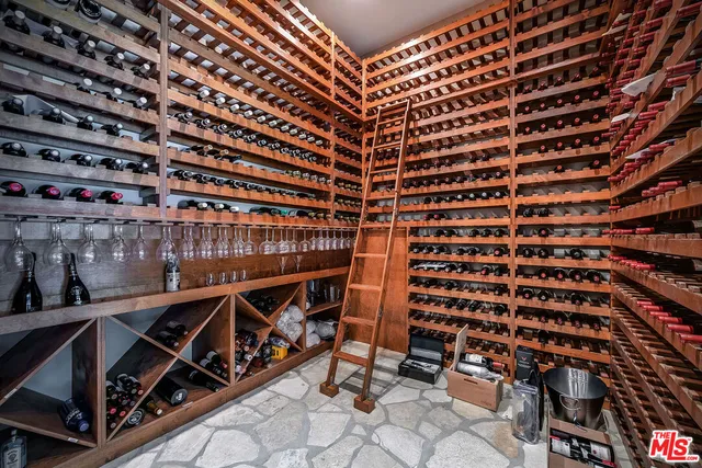 a living room with furniture a flat screen tv and floor to ceiling window