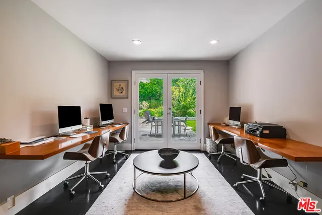 a spacious bedroom with a bed and a large window