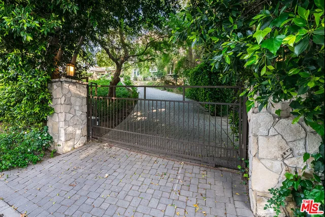 a front view of a house with a yard and a garden