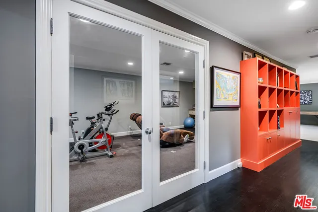 a view of a backyard with lawn chairs and plants