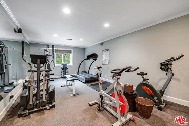 a view of a patio with table and chairs potted plants and large tree