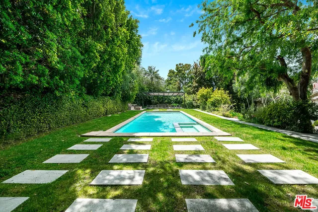 an aerial view of a house with a swimming pool yard and outdoor seating