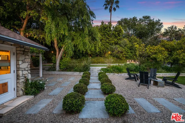 a outdoor living space with furniture and a fireplace