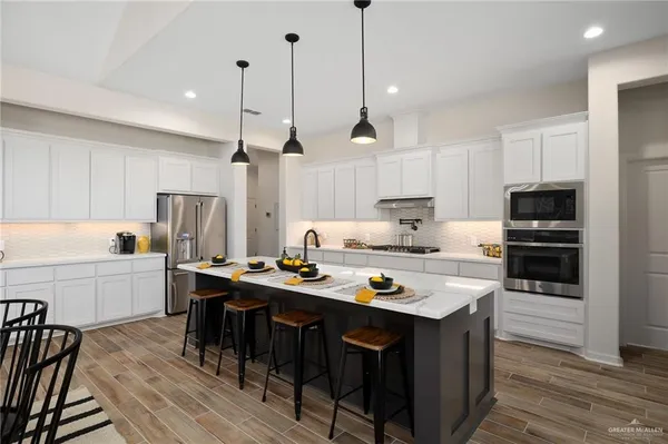 a kitchen with a table chairs stove and white cabinets