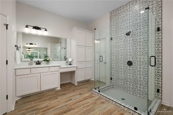 a bathroom with a shower sink and mirror