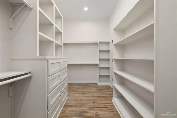 a view of walk in closet with empty racks