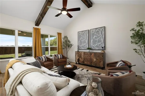 a living room with furniture and a floor to ceiling window
