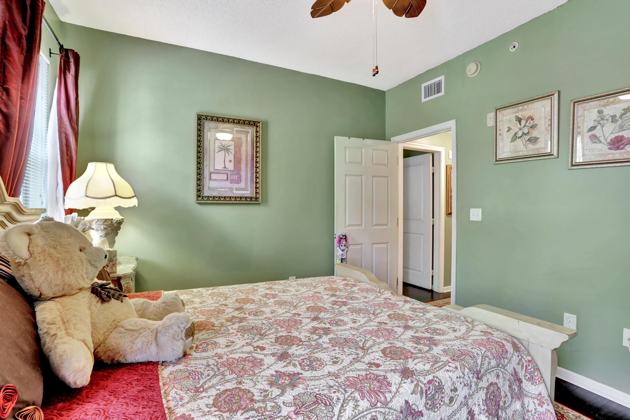 5800 West Sample Road, Unit 206 Coral Springs, FL 33067 - Photo 17 of 24 a bedroom with a bed and a chandelier