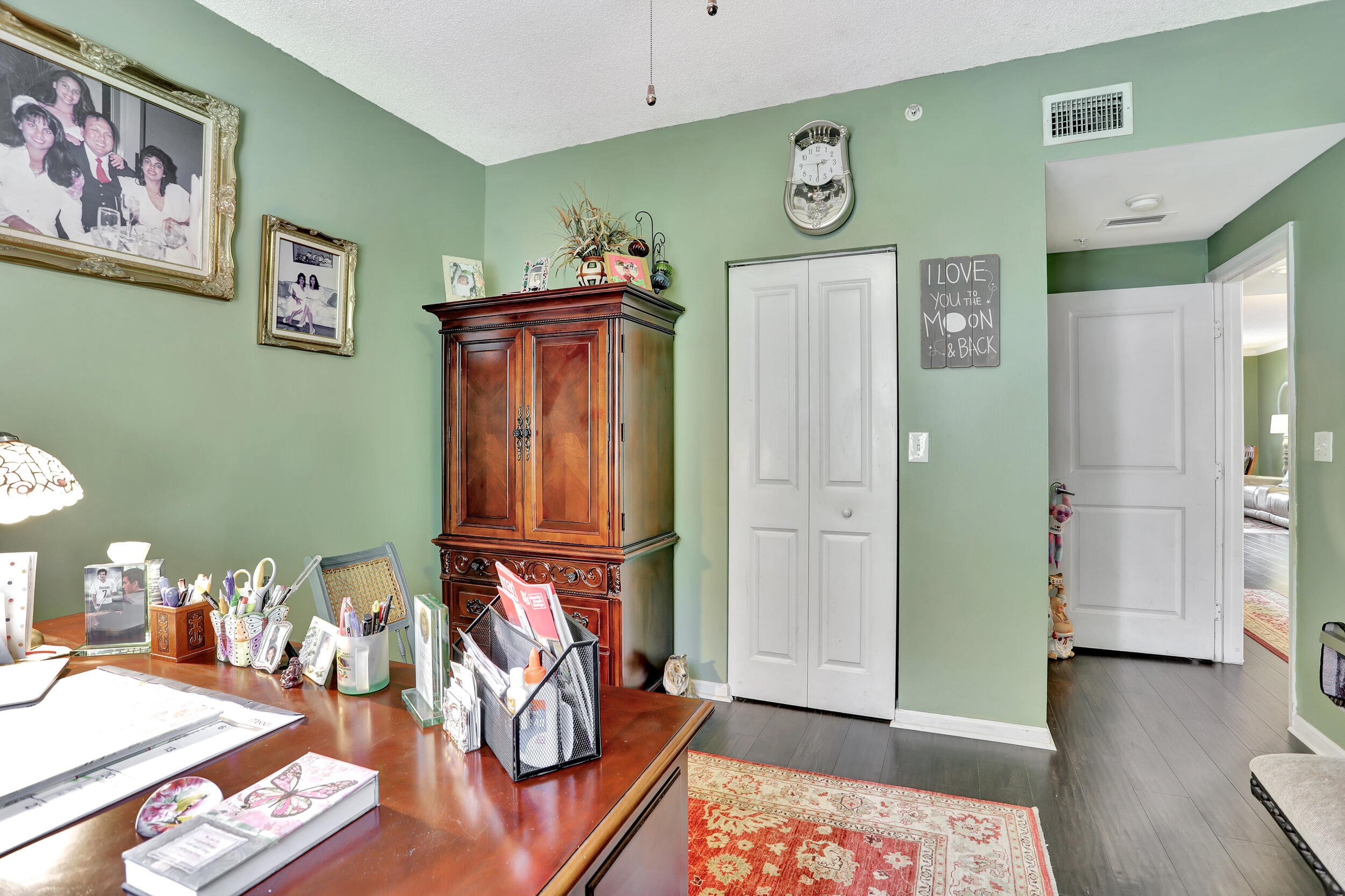 5800 West Sample Road, Unit 206 Coral Springs, FL 33067 - Photo 19 of 24 a view of a hallway with workspace and wooden floor