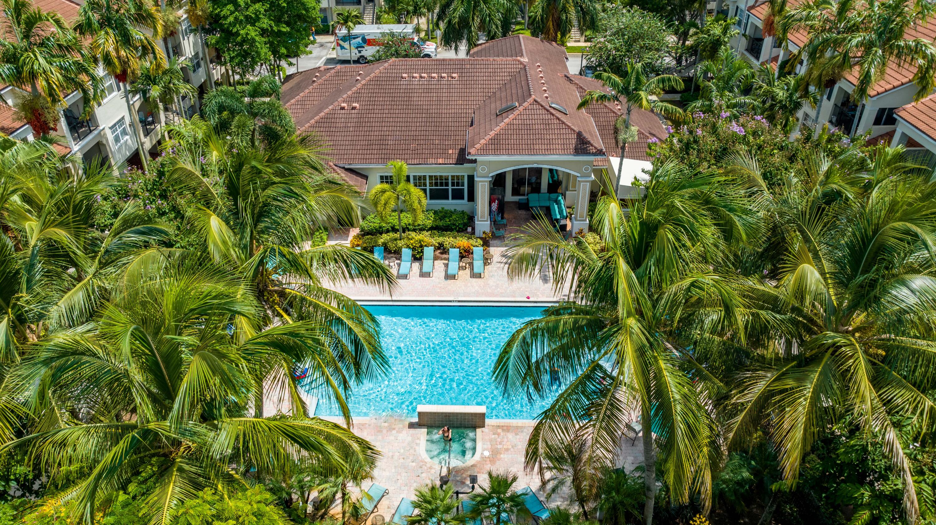 5800 West Sample Road, Unit 206 Coral Springs, FL 33067 - Photo 20 of 24 a view of a table and chairs under an umbrella