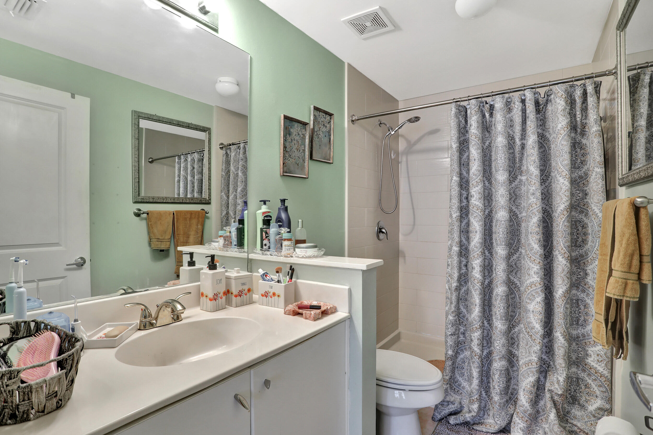 5800 West Sample Road, Unit 206 Coral Springs, FL 33067 - Photo 22 of 24 a bathroom with a granite countertop sink toilet and shower