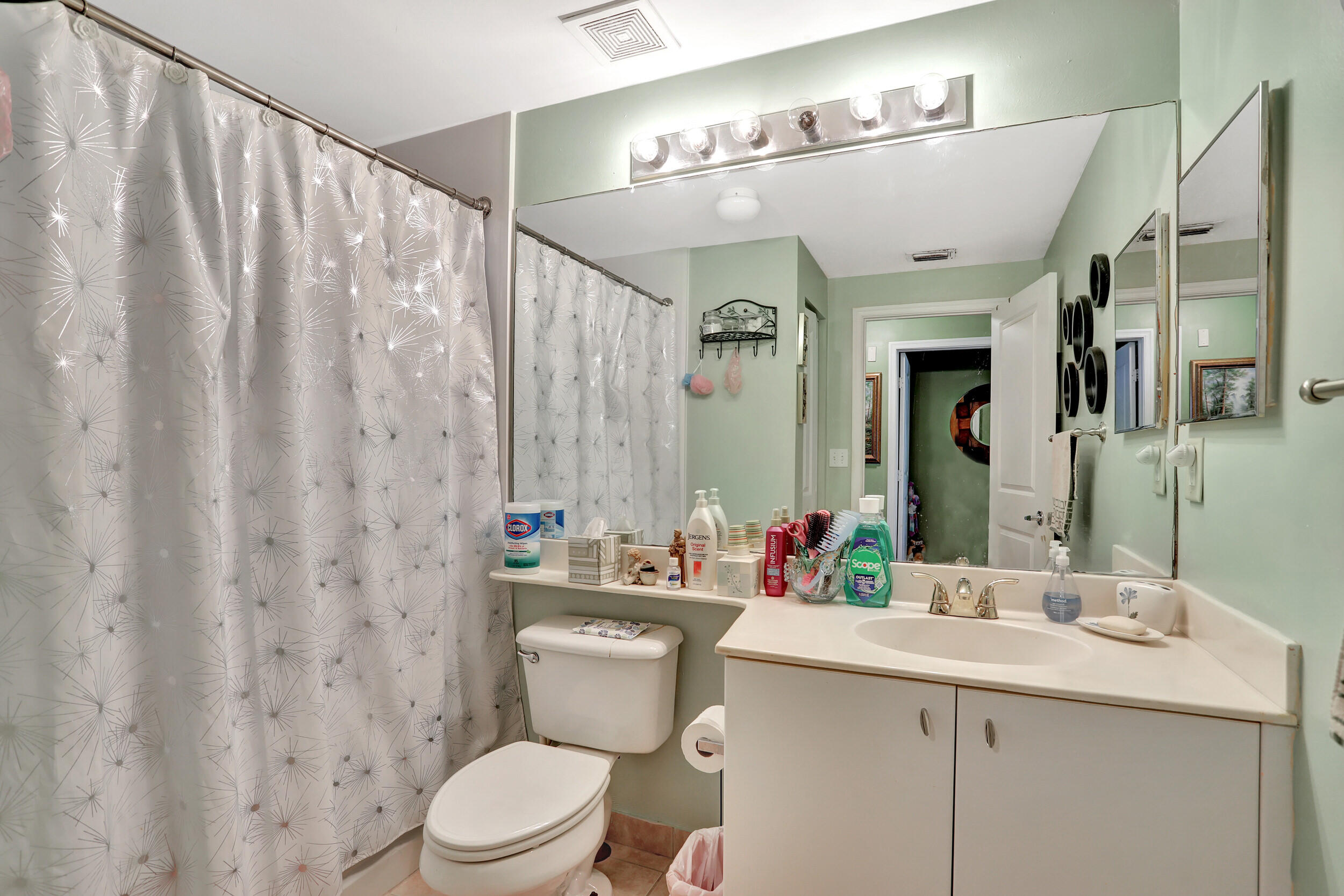 5800 West Sample Road, Unit 206 Coral Springs, FL 33067 - Photo 23 of 24 a bathroom with a sink mirror vanity and toilet