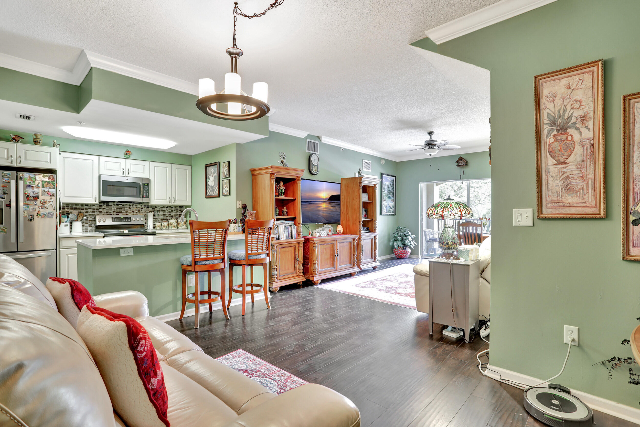 5800 West Sample Road, Unit 206 Coral Springs, FL 33067 - Photo 3 of 24 a living room with lots of furniture and kitchen view
