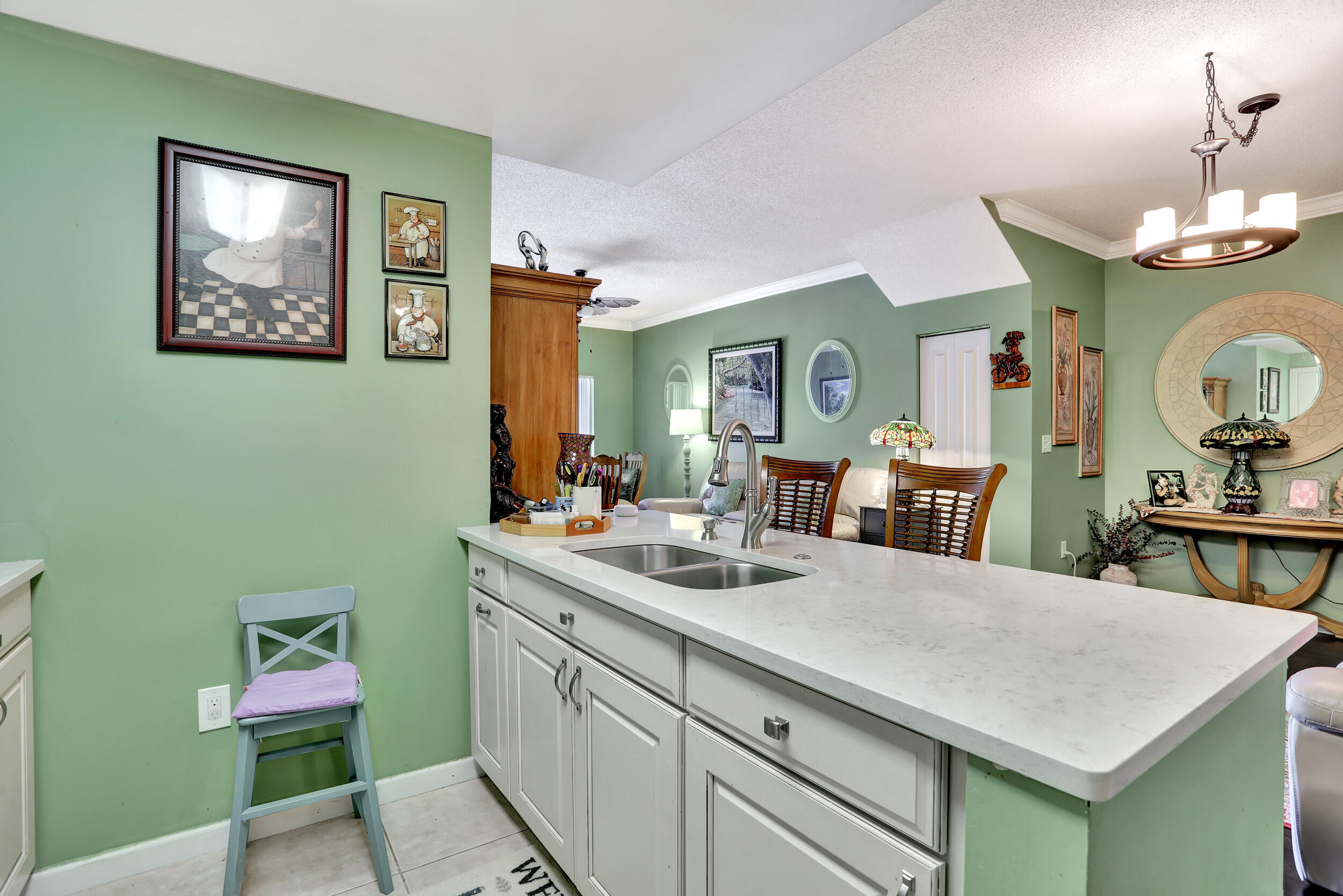 5800 West Sample Road, Unit 206 Coral Springs, FL 33067 - Photo 6 of 24 a view of kitchen island with furniture and wooden floor