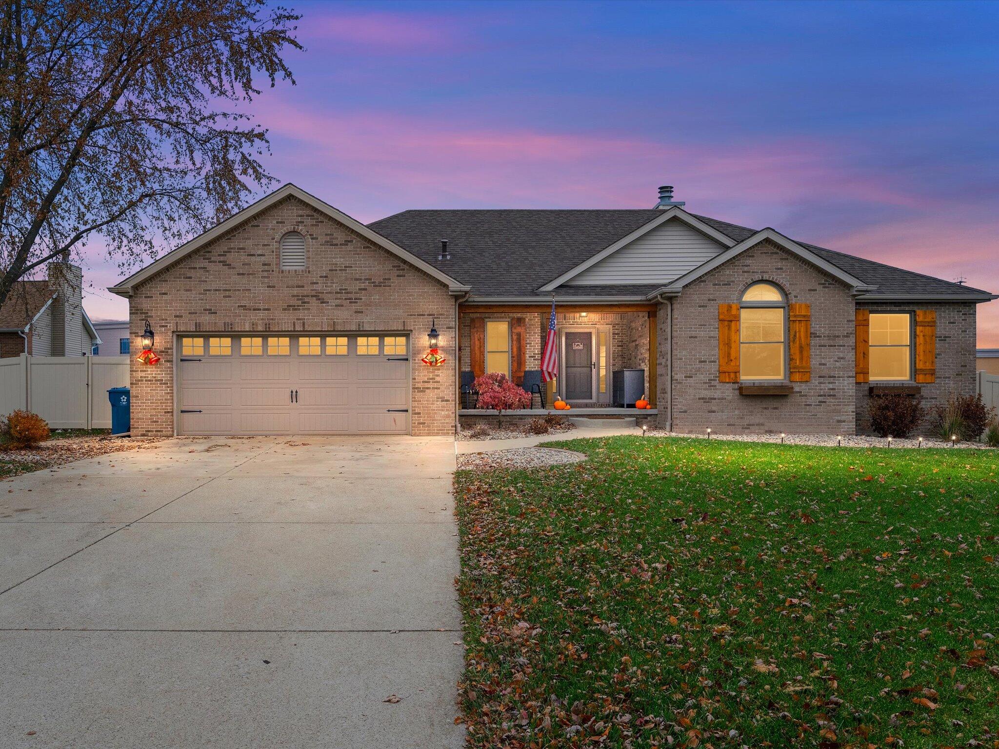 8407 Heron Lake Road St. John, IN 46373 - Photo 1 of 22 a front view of a house with a yard and garage