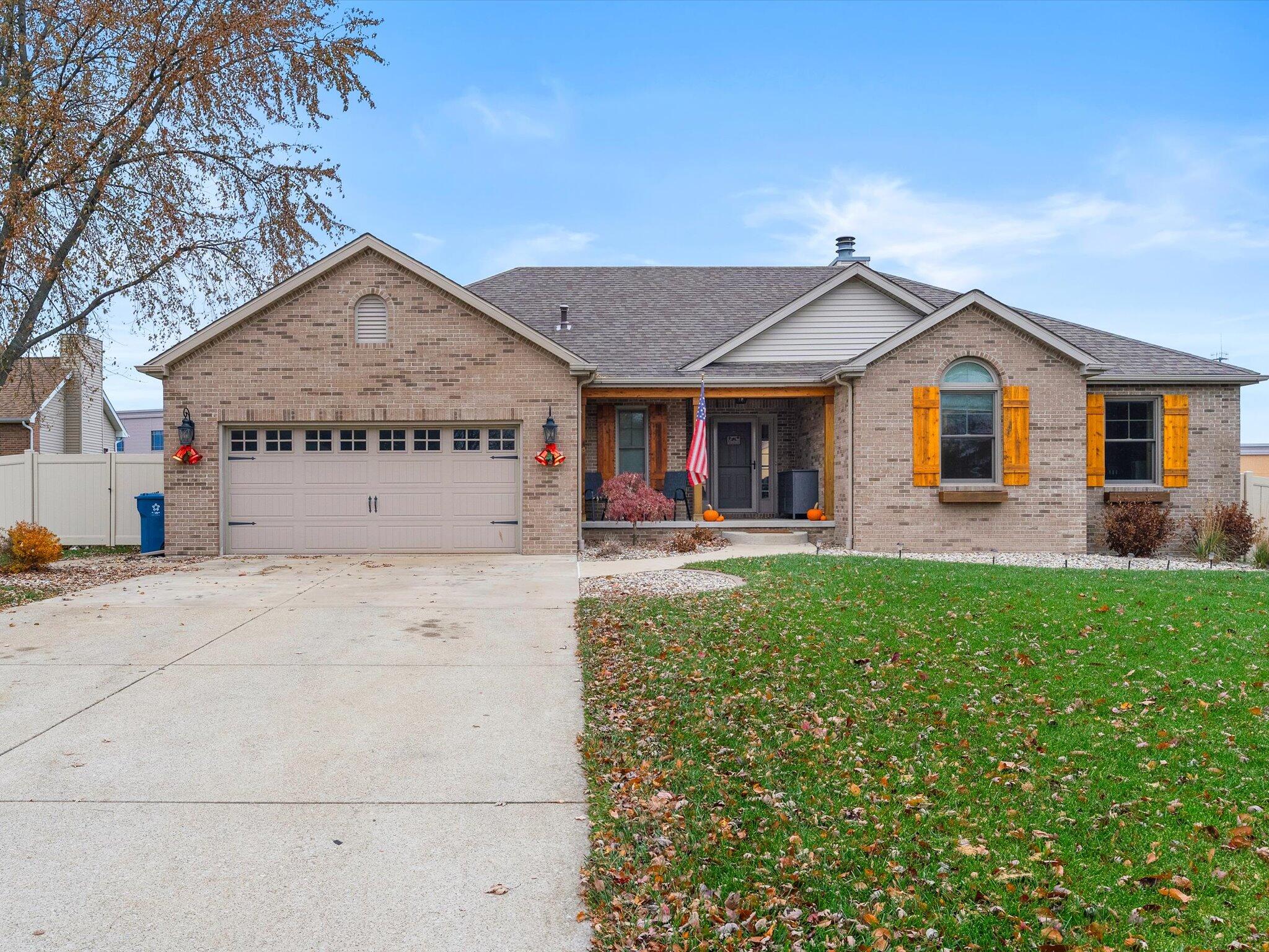 8407 Heron Lake Road St. John, IN 46373 - Photo 2 of 22 a front view of a house with garden
