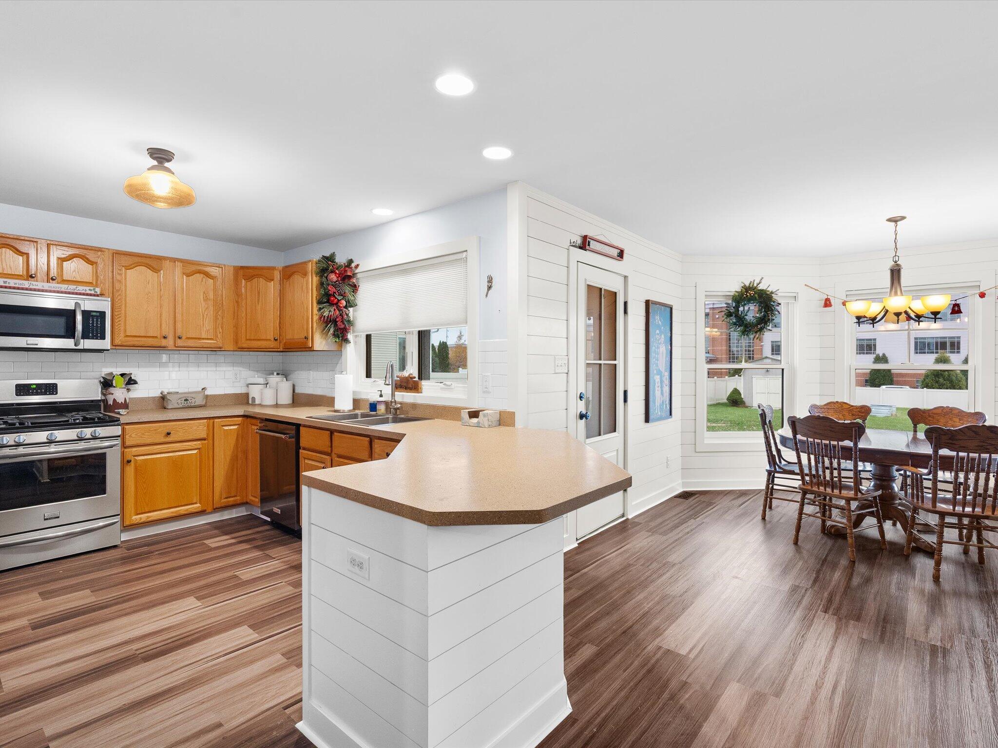 8407 Heron Lake Road St. John, IN 46373 - Photo 3 of 22 a kitchen with a sink appliances and wooden floor