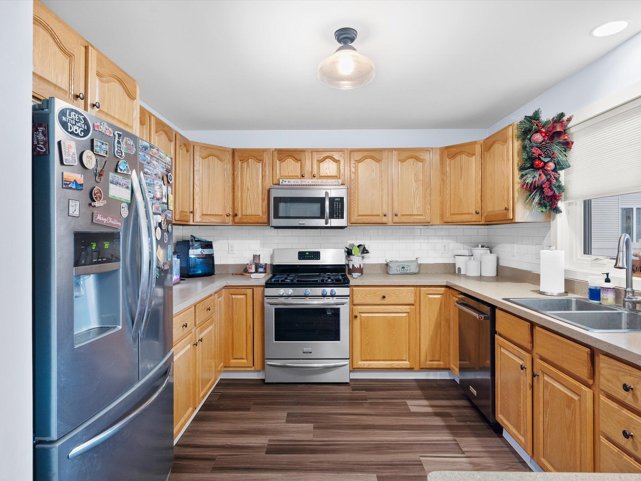 8407 Heron Lake Road St. John, IN 46373 - Photo 10 of 22 a kitchen with stainless steel appliances granite countertop a refrigerator and a stove top oven
