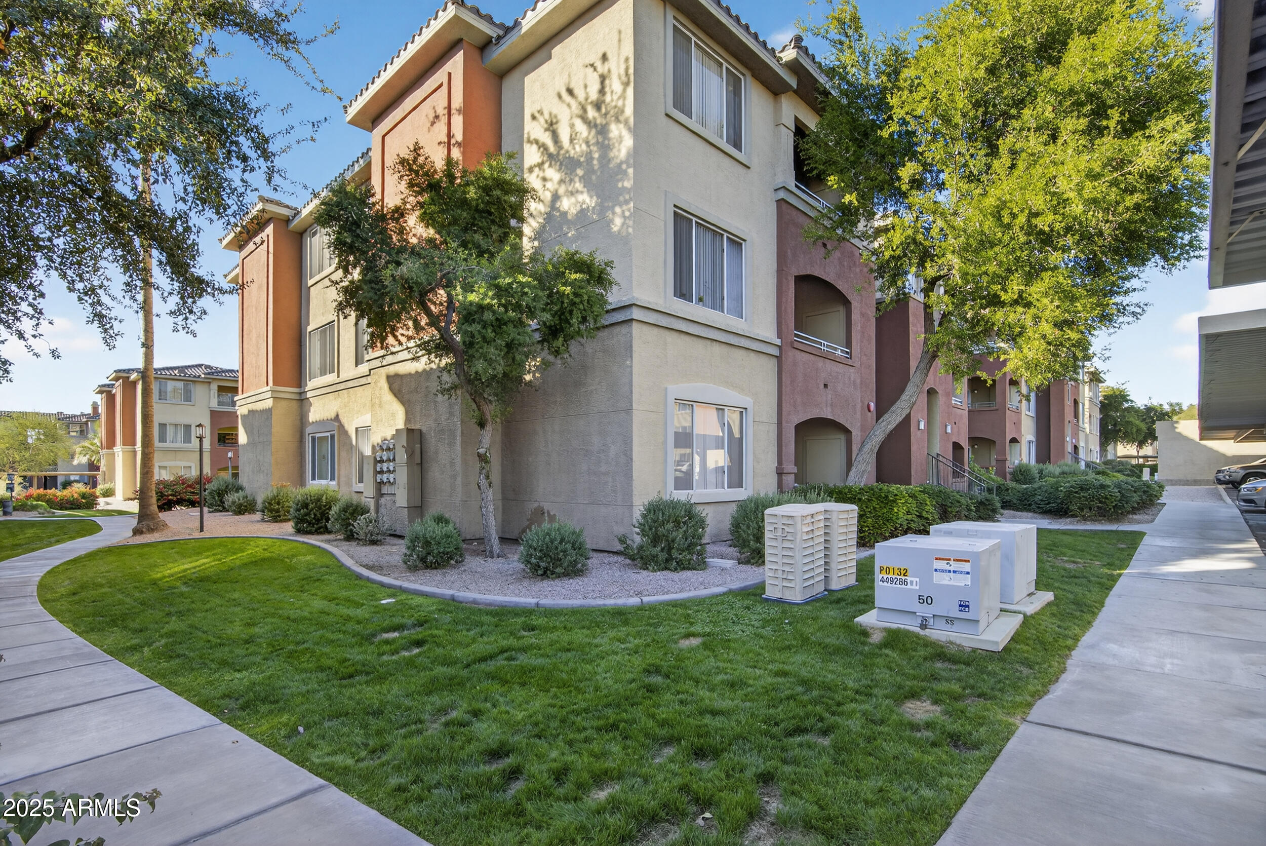 5401 East Van Buren Street, Unit 2076 Phoenix, AZ 85008 - Photo 1 of 41 a front view of a house with garden and trees