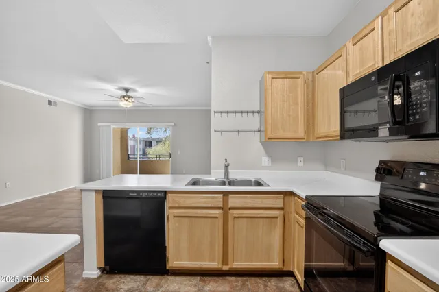 a kitchen with stainless steel appliances a sink stove and cabinets