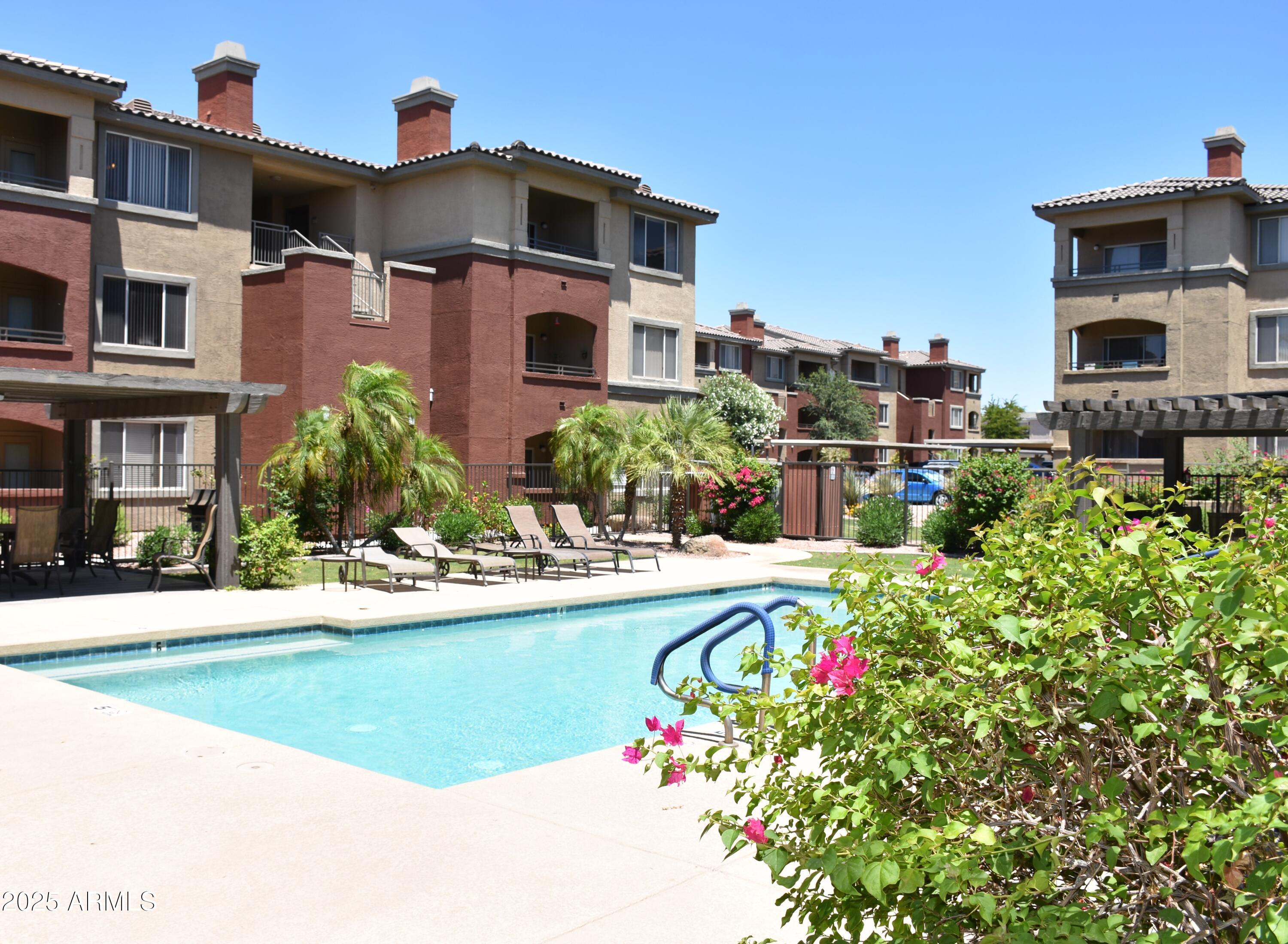 5401 East Van Buren Street, Unit 2076 Phoenix, AZ 85008 - Photo 31 of 41 a front view of a house with a yard