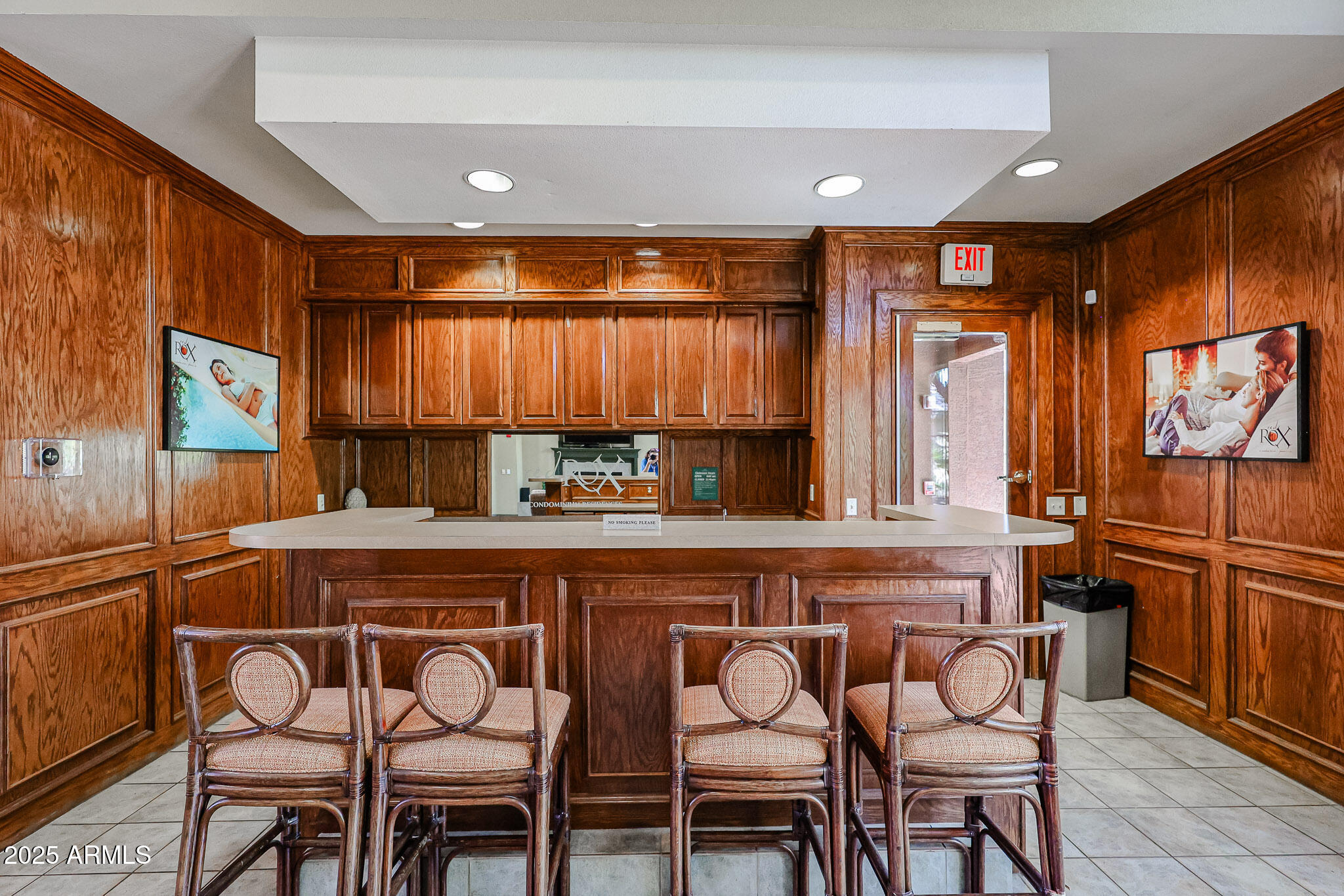 5401 East Van Buren Street, Unit 2076 Phoenix, AZ 85008 - Photo 35 of 41 a kitchen with stainless steel appliances granite countertop a table chairs sink and wooden cabinets