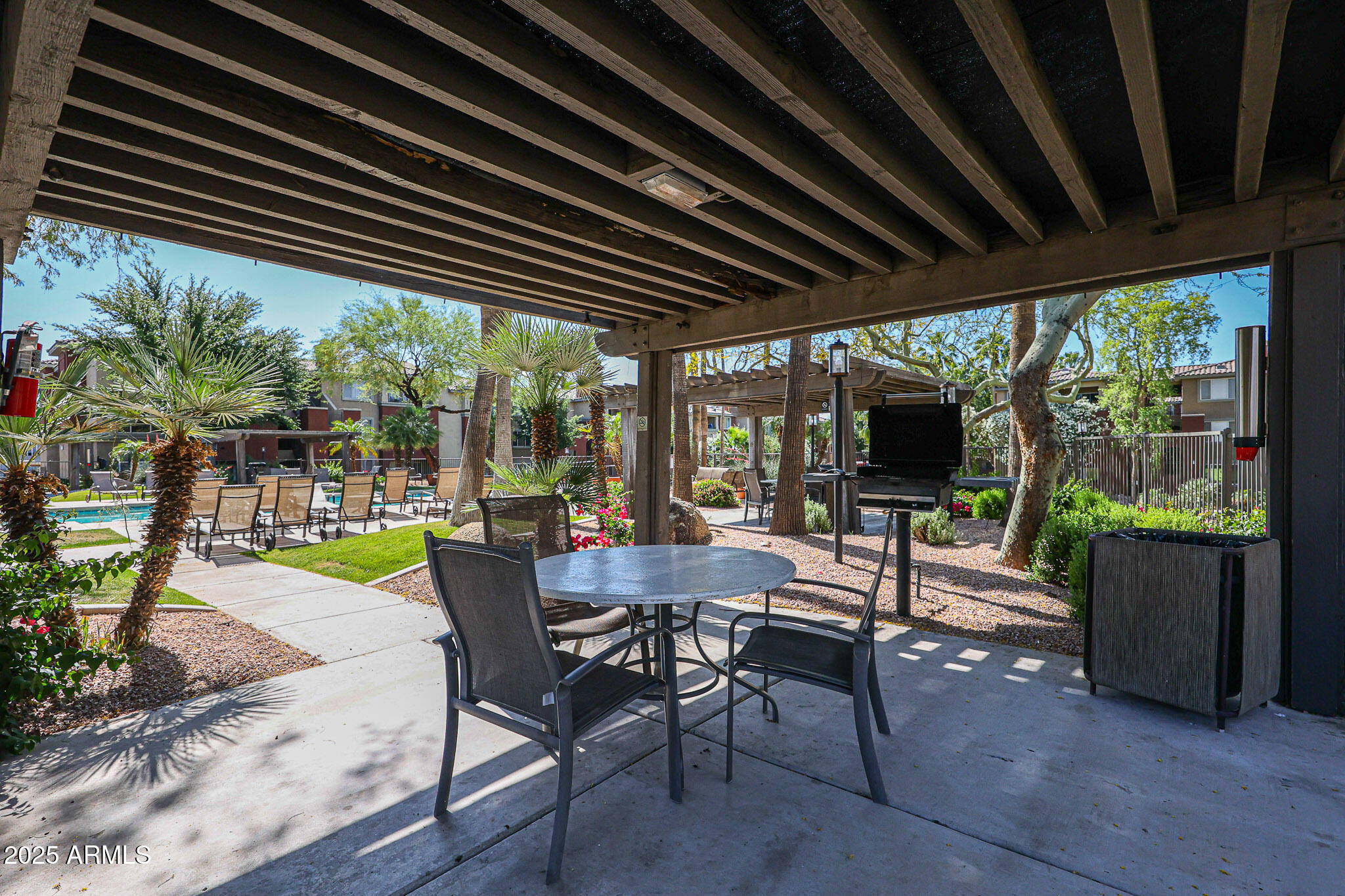 5401 East Van Buren Street, Unit 2076 Phoenix, AZ 85008 - Photo 41 of 41 a view of a patio with a table chairs and a grill