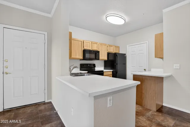 a kitchen with stainless steel appliances a refrigerator stove microwave and sink