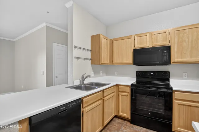 a kitchen with a sink stove and microwave
