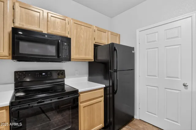 a kitchen with granite countertop cabinets and steel stainless steel appliances