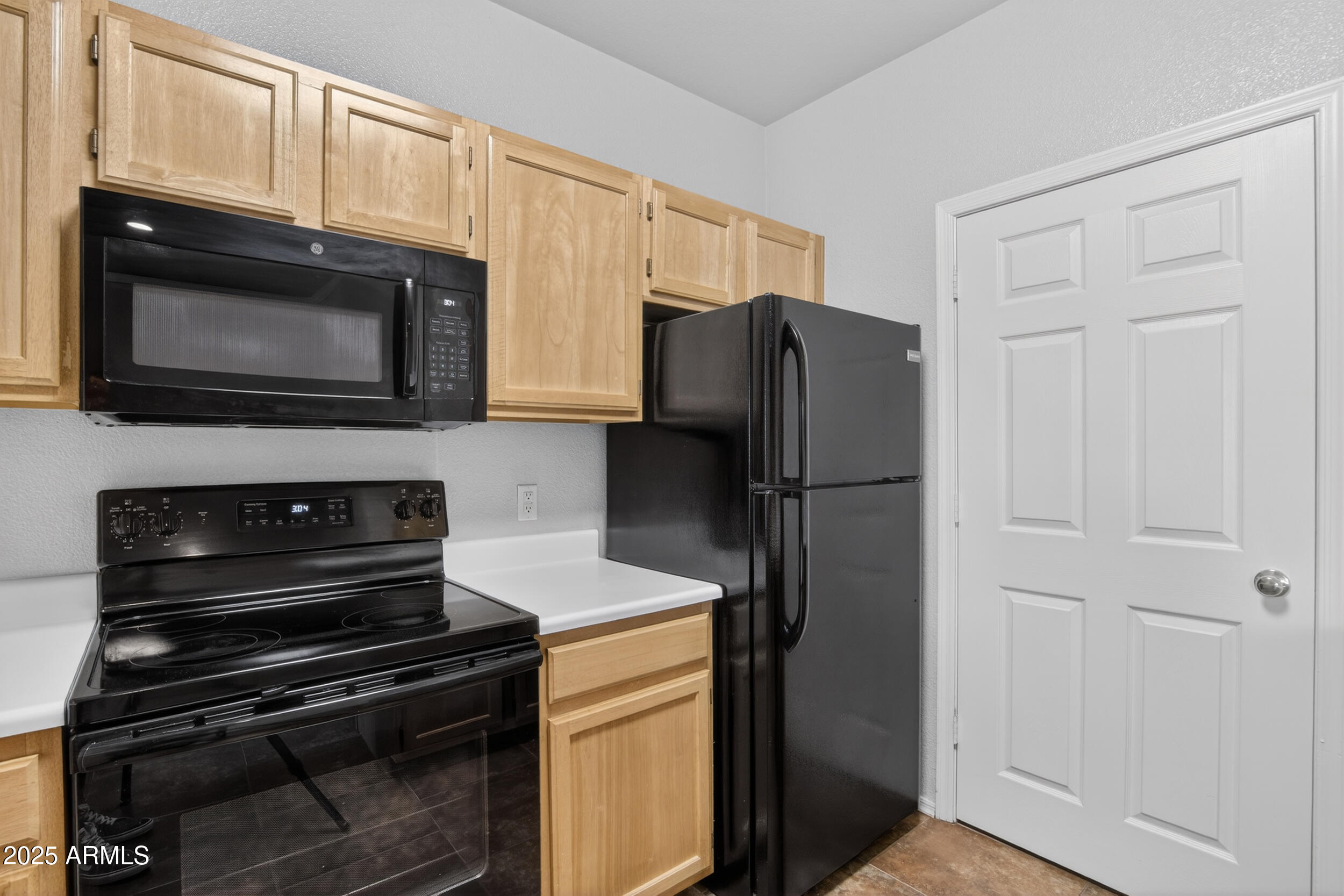 5401 East Van Buren Street, Unit 2076 Phoenix, AZ 85008 - Photo 9 of 41 a kitchen with granite countertop cabinets and steel stainless steel appliances