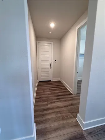 a view of a room with wooden floor and window