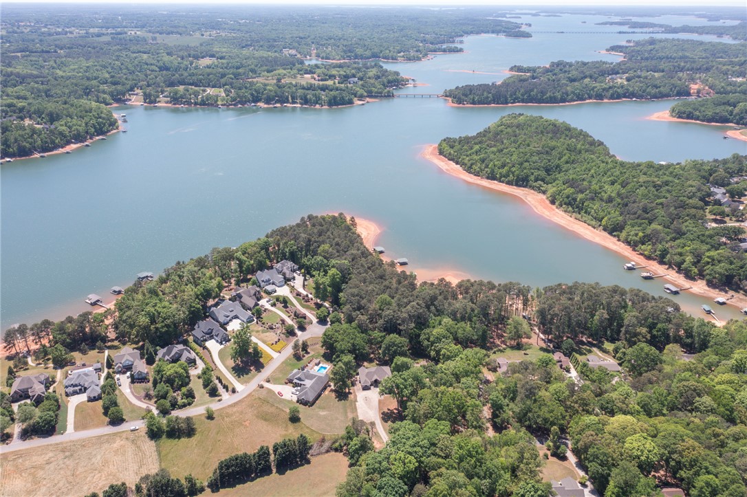4420 Denver Cove Road Anderson, SC 29625 - Photo 12 of 50 This captivating aerial view showcases waterfront residences nestled along a serene lake.